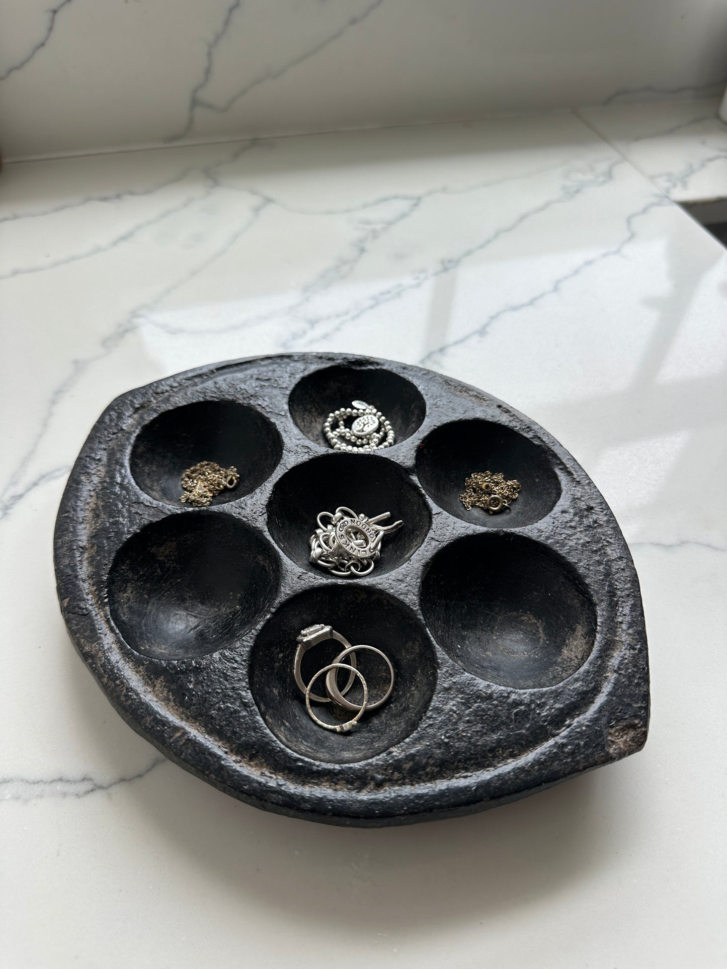 Hand-carved stone Idli plate from India.