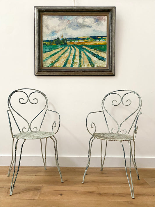 A Pair Of Wrought Iron Garden Armchairs