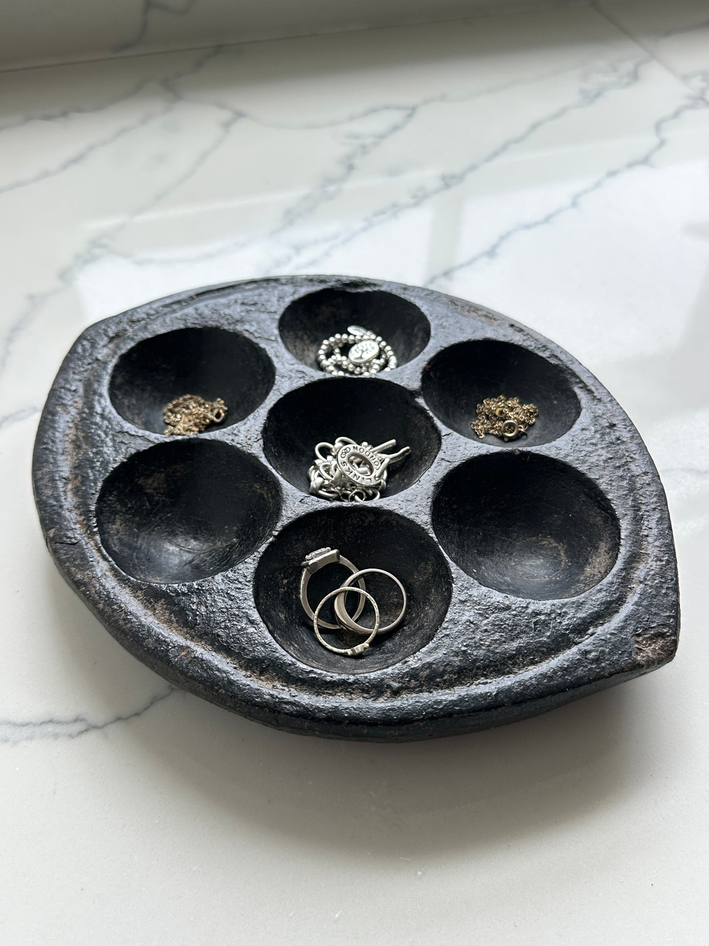 Hand-carved stone Idli plate from India.