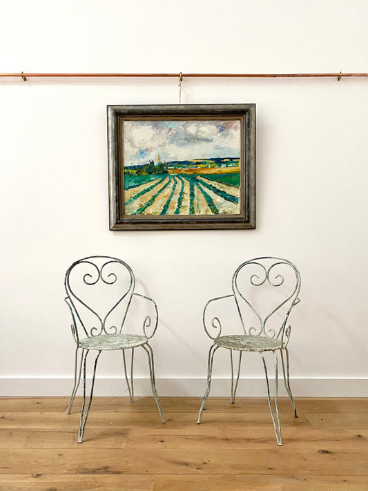 A Pair Of Wrought Iron Garden Armchairs