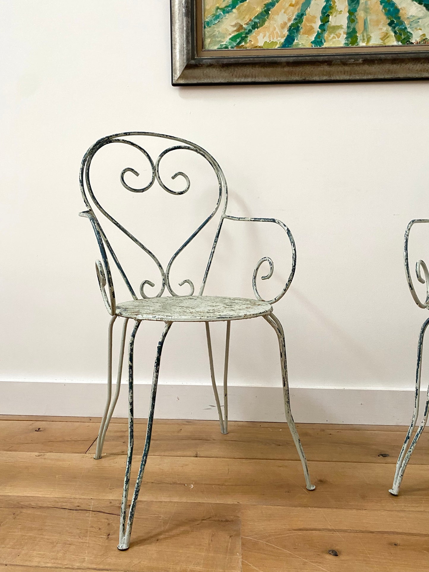 A Pair Of Wrought Iron Garden Armchairs