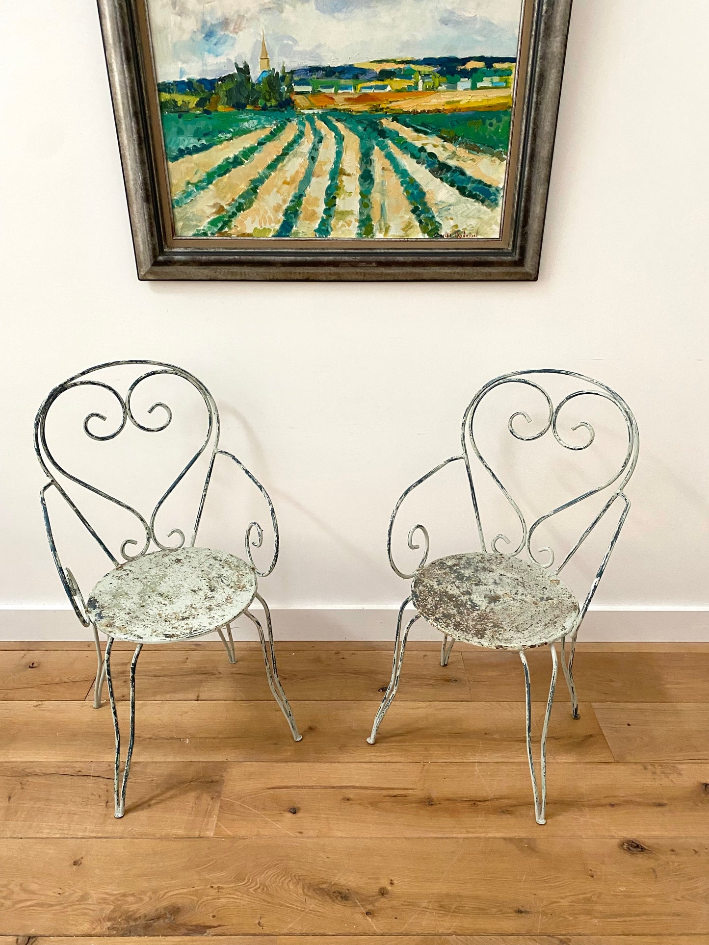 A Pair Of Wrought Iron Garden Armchairs