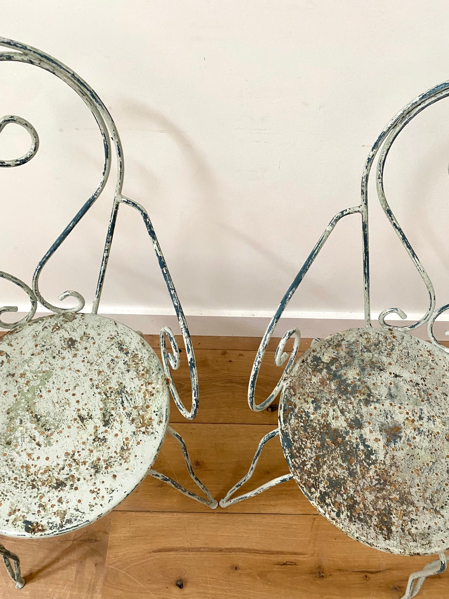 A Pair Of Wrought Iron Garden Armchairs