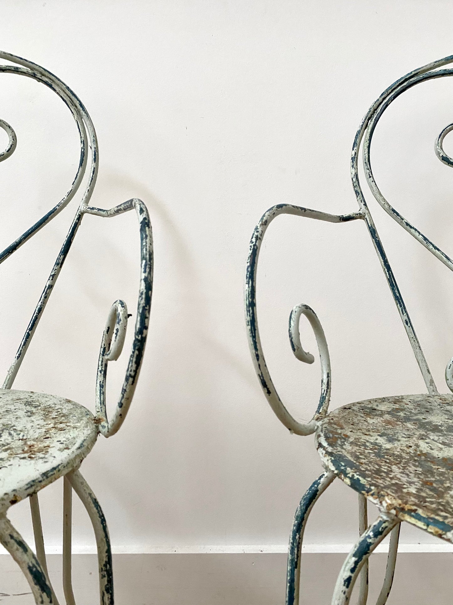 A Pair Of Wrought Iron Garden Armchairs